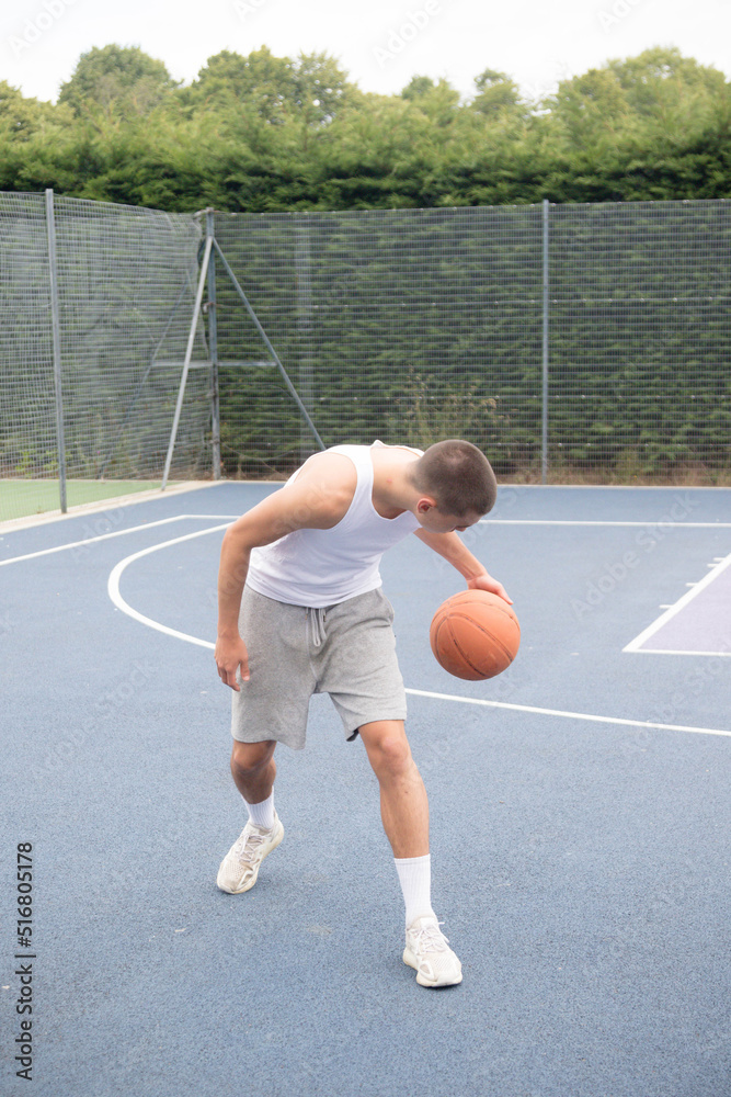 A Nineteen Year Old Teenage Boy Playing Basketball A Nineteen Year Old Teenage Boy Playing Basketball