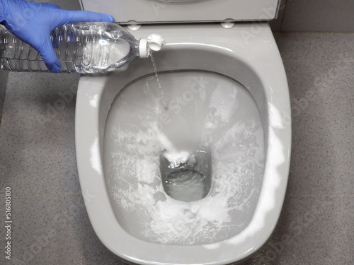 Toilet bowl, baking soda and white vinegar. Ecological cleaning. Selective focus