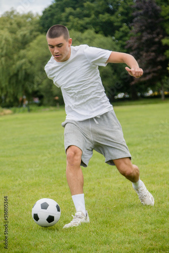 A Nineteen Year Old Teenage Boy Playing Football in A Public Park © Ben Gingell
