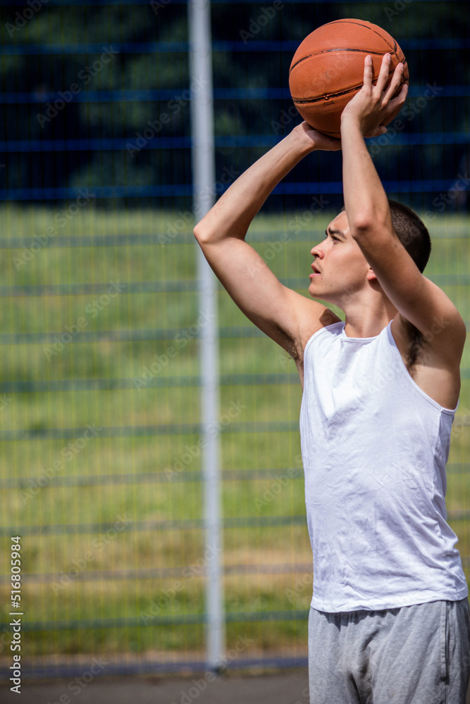 A Nineteen Year Old Teenage Boy Playing Basketball A Nineteen Year Old Teenage Boy Playing Basketball