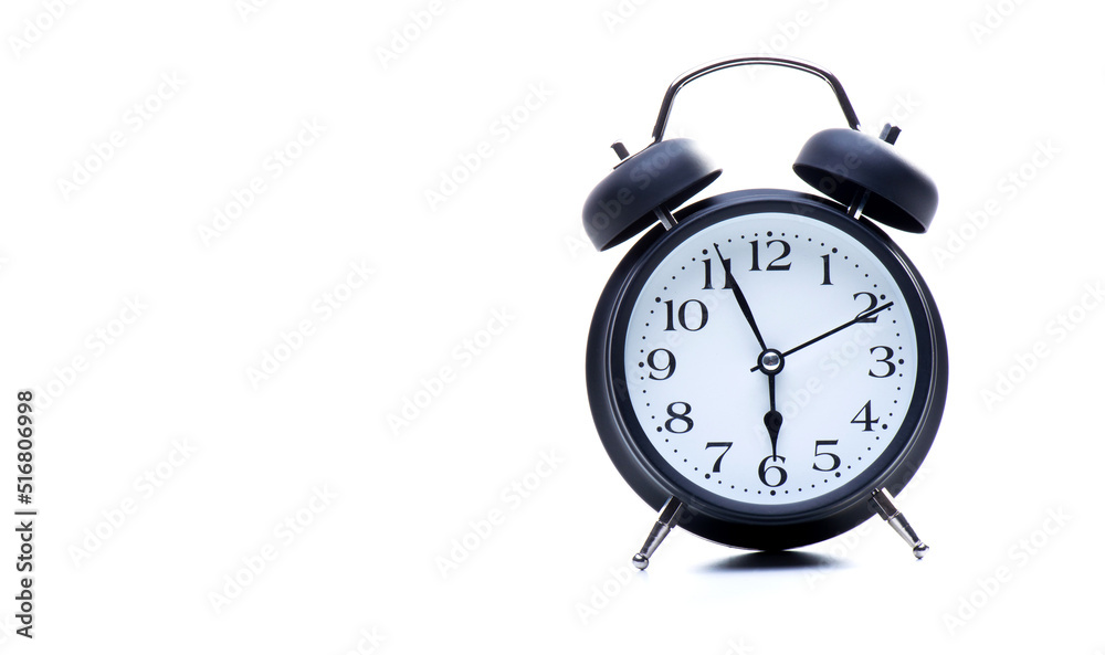 Black round retro alarm clock on a white background. The concept of mode and time Black round retro alarm clock on a white background. The concept of mode and time