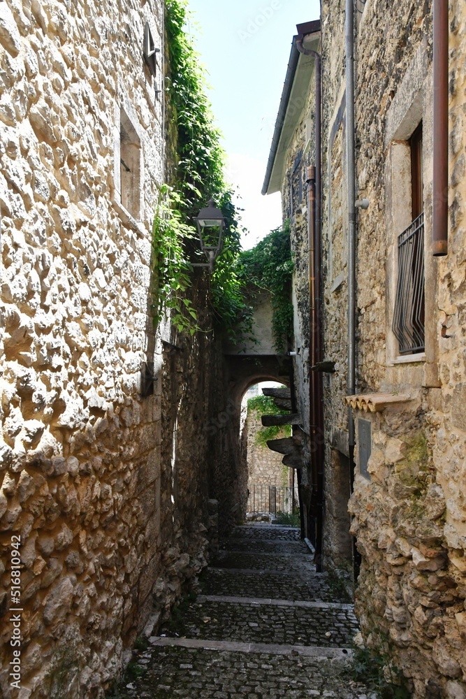 A narrow street between the old stone houses of Campo di Giove, a medieval village in the Abruzzo region of Italy.