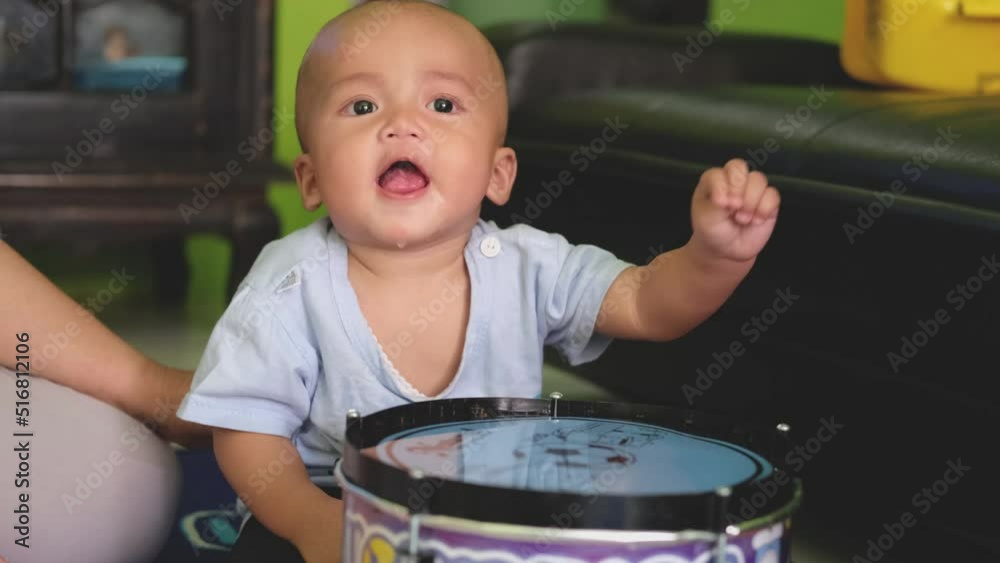 child baby boy playing with drum toys. funny expression of little baby child baby boy playing with drum toys. funny expression of little baby