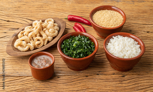 Typical brazilian feijoada side dishes. Rice, kale, pepper, farofa and cracklings