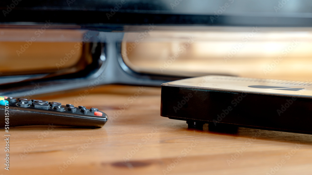 TV set-top box on a wooden background in