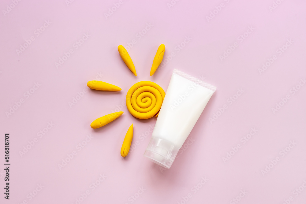 Sun protection lotion and plasticine sun. Summer skin care concept