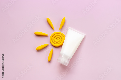 Sun protection lotion and plasticine sun. Summer skin care concept