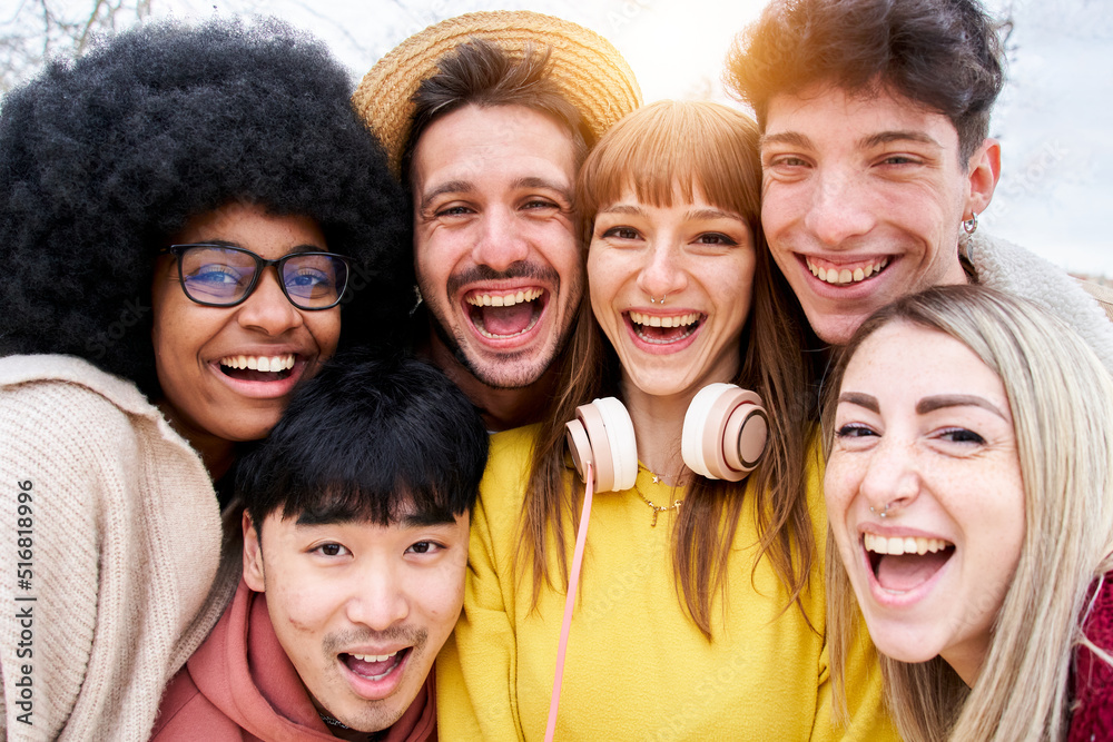Fototapeta premium Portrait of Cheerful group of friends taking smiling selfie. Group of young students having fun together outdoors at university campus.