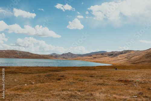 beautiful landscape of Shausar Lake with mountain range in Deosai National Park on a sunny summer day in Pakistan