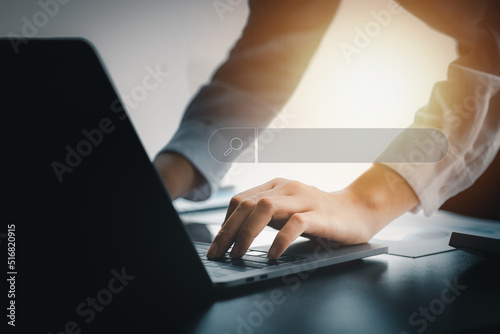 A person is typing on a laptop keyboard and has search frame graphics, Internet browsing through web browsers, online search technology, Search Engine Optimization. Website search concept.
