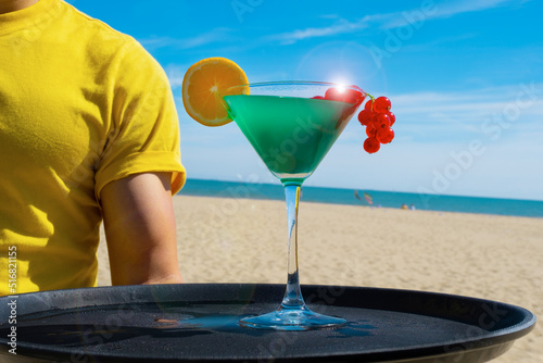 cocktail blue curacao green currant orange sand beach sea hand tray waiter