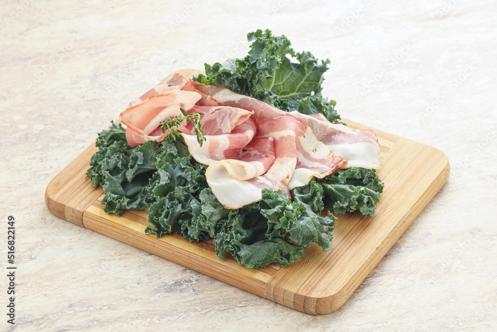 Raw pork bacon over board