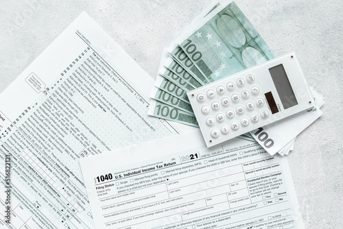 Annual tax form under US law with culculator. Tax payment concept photo