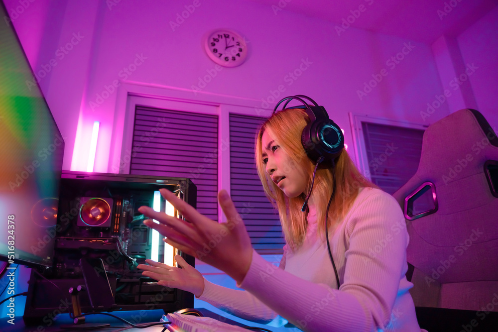 A Professional female pro gamer play online video games cyber sport and esport anger lose emotion. Young woman in tournament match worldwide in room colorful neon lights. A Professional female pro gamer play online video games cyber sport and esport anger lose emotion. Young woman in tournament match worldwide in room colorful neon lights.