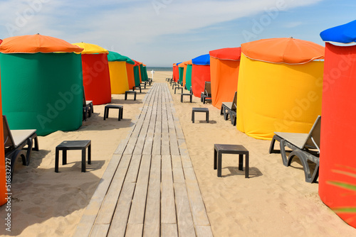 The typical colored tents and beach chairs