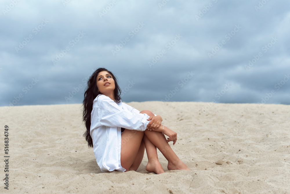 Girl in the dunes on a cloudy day