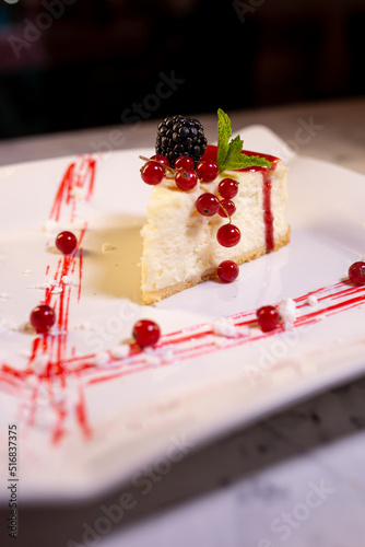 tender cheesecake with lingonberries on a white plate