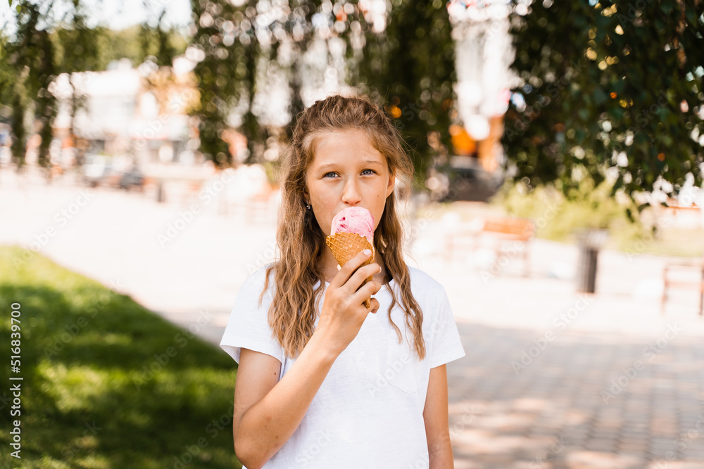 Funny child girl eating ice cream cone in waffle cup. Creative advert for ice cream stand and shop. Funny child girl eating ice cream cone in waffle cup. Creative advert for ice cream stand and shop.