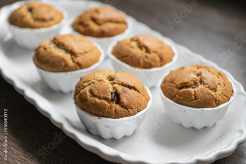 Sweet muffins freshly baked on modern white plate