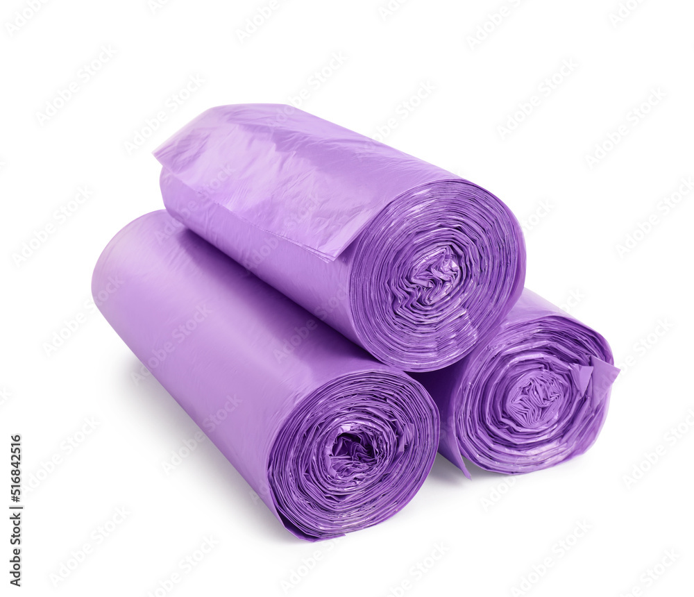 Rolls of violet garbage bags on white background. Cleaning supplies Rolls of violet garbage bags on white background. Cleaning supplies