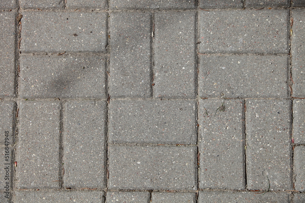 Obraz premium Paving of streets with gray paving slabs. Improvement of the city. Background texture.