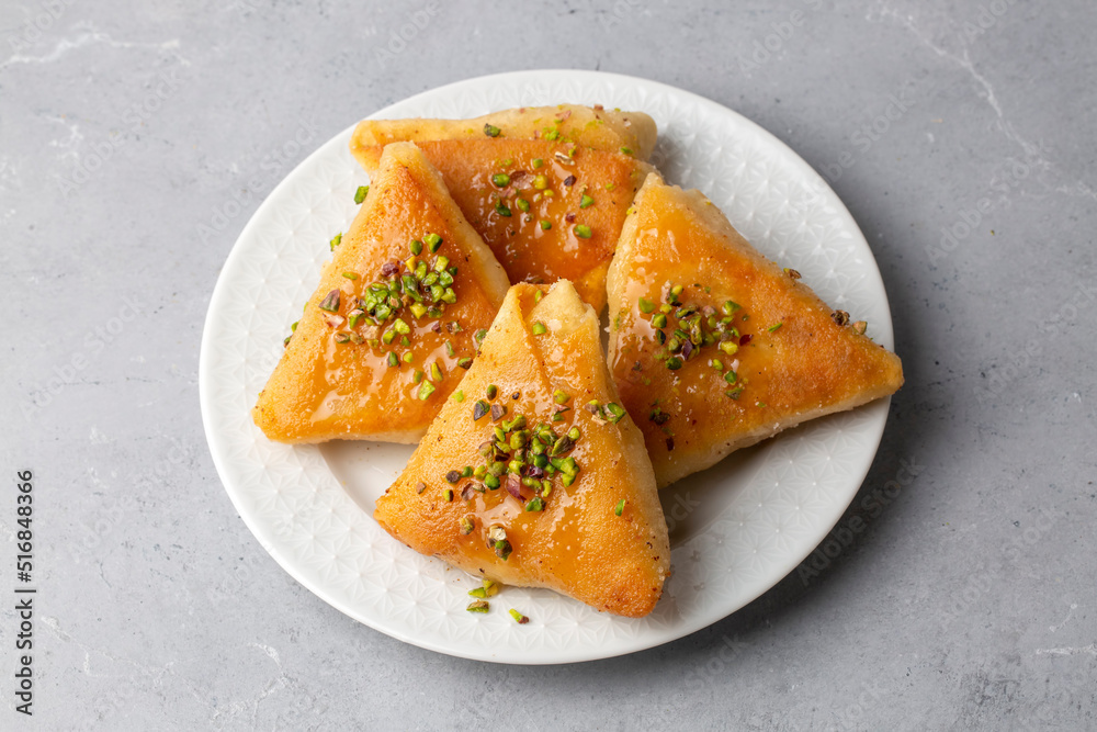 Traditional Turkish desserts; custard triangular dessert, albanian dessert ( Turkish name; Arnavut tatlisi or muhallebili muska tatlisi) Traditional Turkish desserts; custard triangular dessert, albanian dessert ( Turkish name; Arnavut tatlisi or muhallebili muska tatlisi)