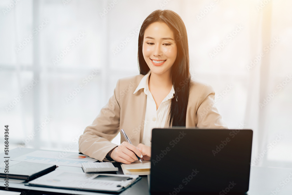 Young asian businesswoman beautiful charming smiling and talking on the mobile phone in the office Young asian businesswoman beautiful charming smiling and talking on the mobile phone in the office