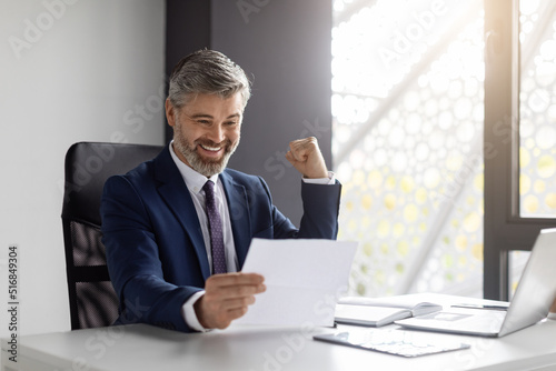 Great News. Portrait Of Happy Excited Middle Aged Businessman Reading Financial Documets