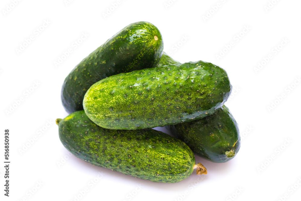 green cucumbers lie on a white background green cucumbers lie on a white background