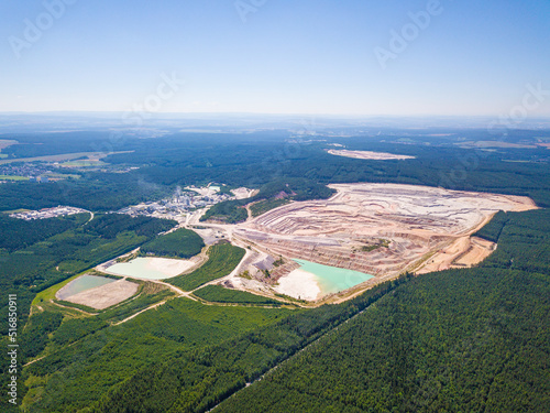 Aerial view of large kaolin open pit mine for ceramics production. Industrial area from above. Kaznejov, Czech republic, European union.
