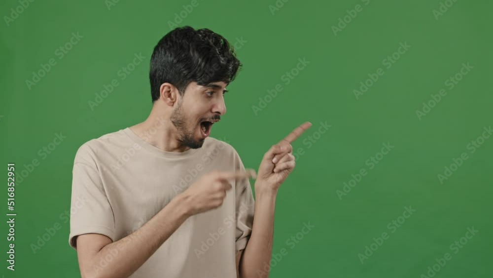 Optimistic humorous portrait arabic man posing in green studio points forefingers aside pretending shooting pistols makes choice thumb up approve good idea advertises promotional product image mockup Optimistic humorous portrait arabic man posing in green studio points forefingers aside pretending shooting pistols makes choice thumb up approve good idea advertises promotional product image mockup