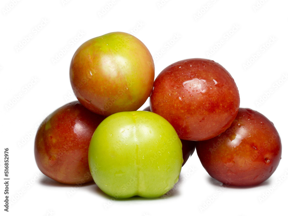 Plums for tkemali sauce. Several cherry plum fruits of varying degrees of ripeness. Plum variety. Juicy fruit. Healthy diet. Plums for tkemali sauce. Several cherry plum fruits of varying degrees of ripeness. Plum variety. Juicy fruit. Healthy diet.