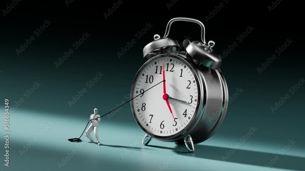 A businessman tries to stop time on an alarm clock. A man pushes back hour arrow A businessman tries to stop time on an alarm clock. A man pushes back hour arrow