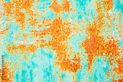 Rusty metal surface with tones of green and orange with strong corrosion