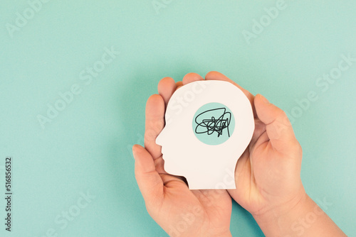 Hands holding a silhouette of a human head, attention deficit hyperactivity disorder, ADHD symptom, mental health 