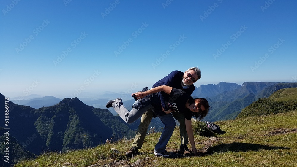 Adult couple playing with mountains in the background