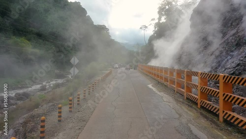 Driving on a road over the Mag Aso Volcanic Steam Spring and Okoy River nature preserve in Valencia, Negros Oriental, Philippines. With copy space. photo