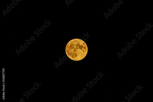 Photo of a full moon with warm tone