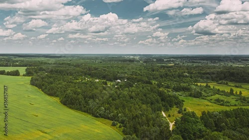 Sky With Clouds On Horizon Above Rural Landscape Young Green Wheat Field. Spring Agricultural Green Field. Time Lapse, Timelapse, Time-lapse. dronelapse, drone lapse, drone Hyper lapse 4K. photo