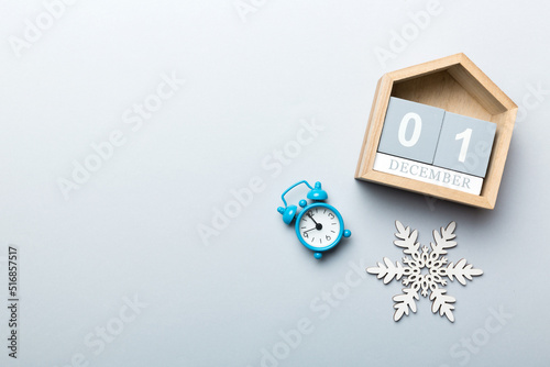 Christmas wood calendar with new year decorations, aganist colored background. Christmas calendar 1 december photo