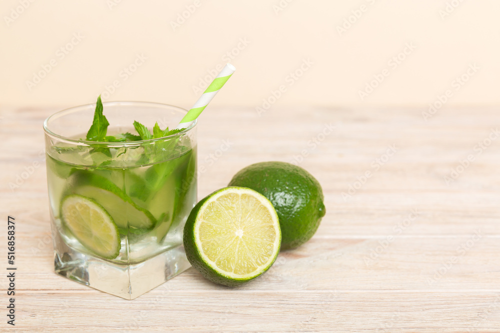 Mojito cocktail. Refreshing mojito cocktail with lime, lemon and mint in a tall glass with a stick Mojito cocktail. Refreshing mojito cocktail with lime, lemon and mint in a tall glass with a stick