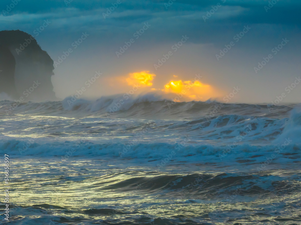 Sunrise at the seaside with large and powerful sets