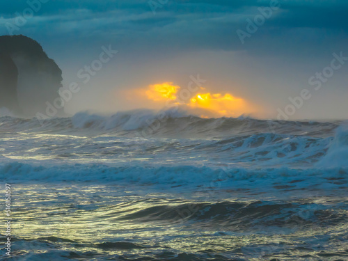 Sunrise at the seaside with large and powerful sets