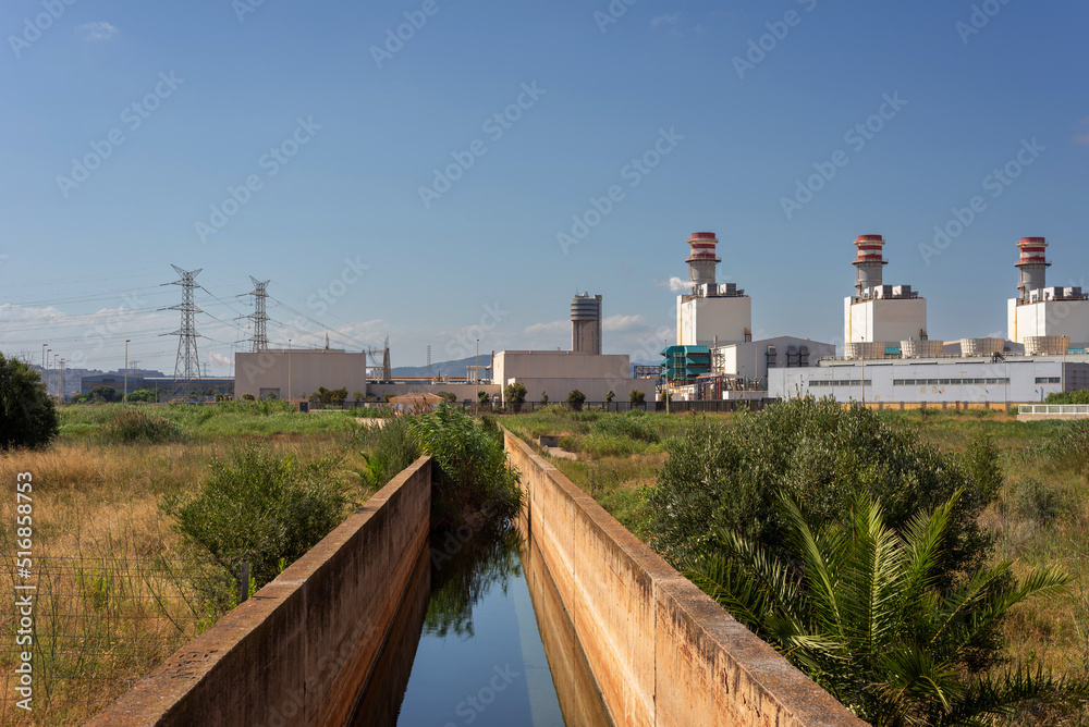 landscape with a water channel heading from the power plant