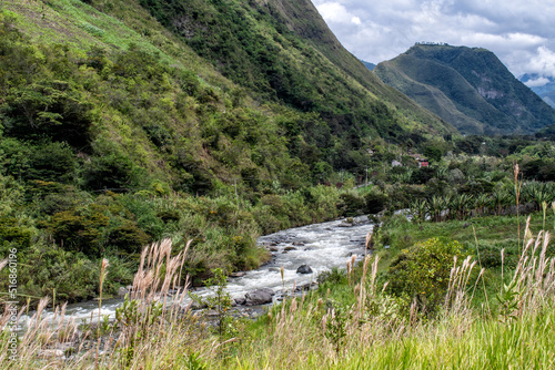 Horizontal shot of river between green mountains photo