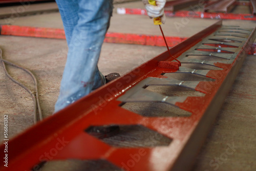 Wallpaper Mural Worker painting steel beam in construction site Torontodigital.ca