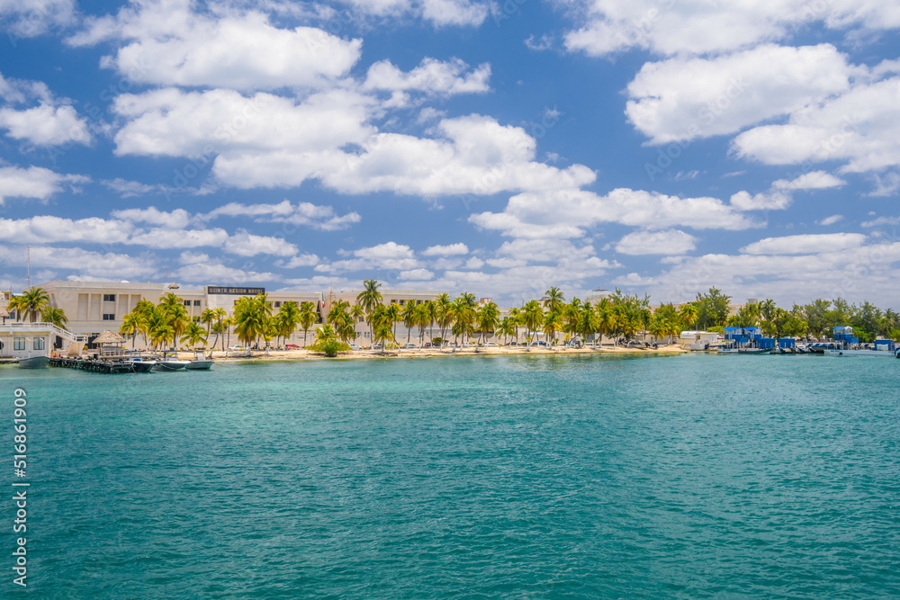 Boats near the coast with palms of Isla Mujeres island in Caribbean Sea, Cancun, Yucatan, Mexico