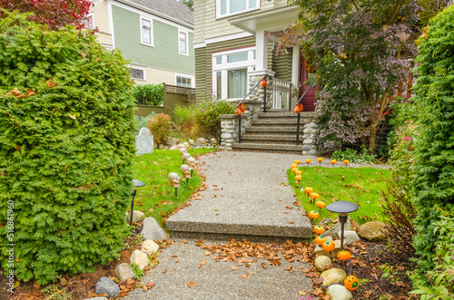 Entrance of painted luxury house with stair steps, green trees and nice landscape in Vancouver, Canada, North America. Day time on June 2021.