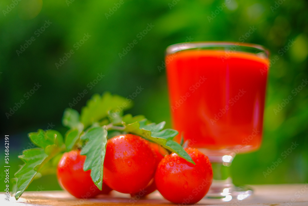 Tomato juice in a goblet and ripe tomatoes .Vegetable natural juices. Red tomato organic juice Tomato juice in a goblet and ripe tomatoes .Vegetable natural juices. Red tomato organic juice