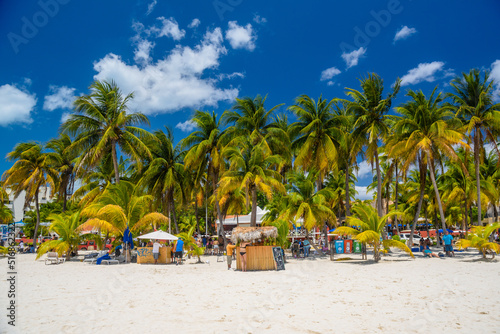 Cocos beach bar on a beach with white sand and palms on a sunny day, Isla Mujeres island, Caribbean Sea, Cancun, Yucatan, Mexico © Eagle2308
